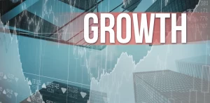 Digital chart with upward trend lines overlaid on skyscrapers, with the word "GROWTH" in bold, signifying economic progress.